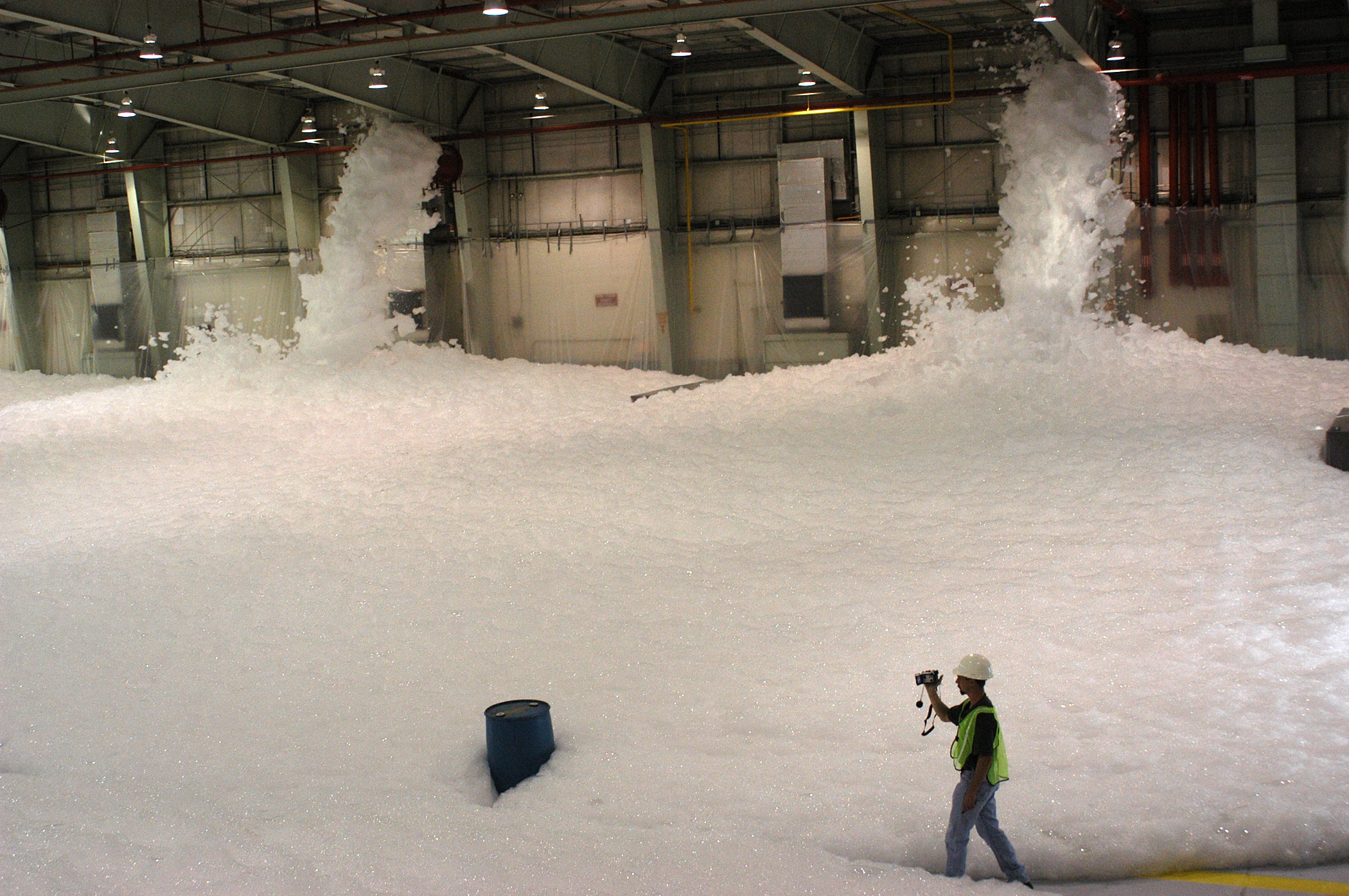 Active high expansion foam generators operating in a large warehouse